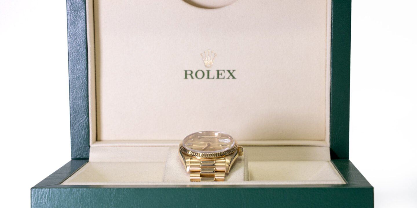 Specialist reviewing artwork, watch documents and luxury items for auction consignment in London