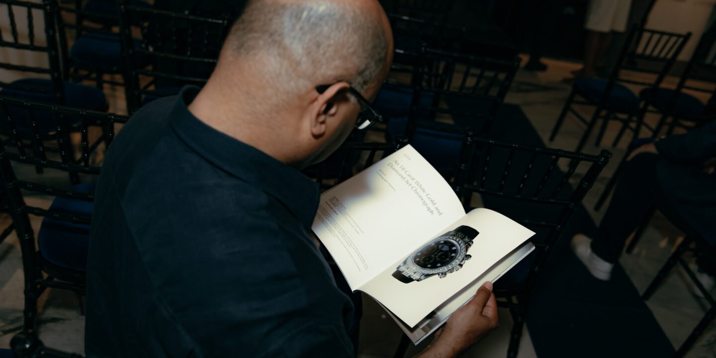 Specialist reviewing artwork, watch documents and luxury items for auction consignment in London