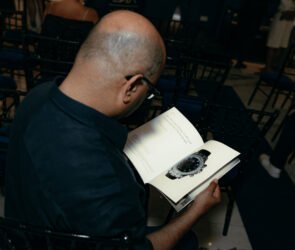 Specialist reviewing artwork, watch documents and luxury items for auction consignment in London